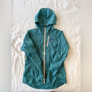 Lightweight teal Patagonia waterproof windbreaker.